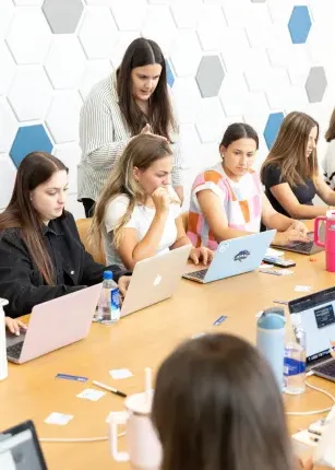 A woman leads a workshop in a UNE conference room