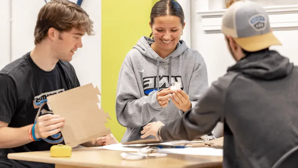 Students smile as they work together in the Makerspace